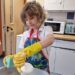 primary school boy washing dishes for a school event which is part of school life in england